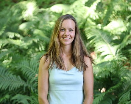 Herbalist Brenna Morris stands in a bank of ferns. (photo courtesy Brenna Morris)