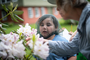 A 2nd grader looks for pollinators during a field trip to the Harris Center. (photo © Ben Conant)