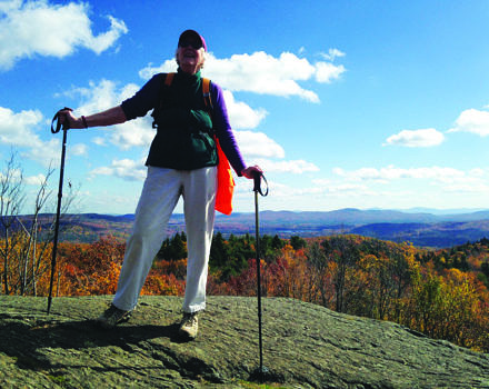 A woman hiker enjoys the summit of Pitcher Mountain. (photo © Janet Altobello)