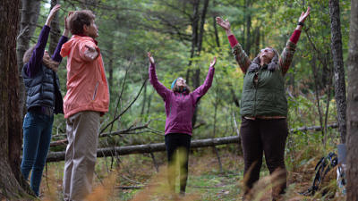 A group practices "forest bathing" with a Harris Center naturalist. (photo © Ben Conant)