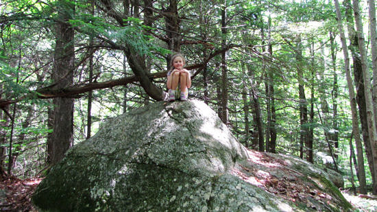 A little girl on a big boulder, during Harris Center summer camp. (photo © Jenna Spear)