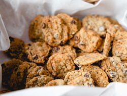 bowl of chocolate chip cookies nestled in a white cloth