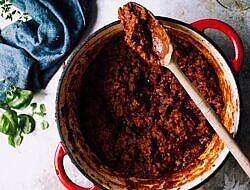 pot of tomato sauce with a spoon in it