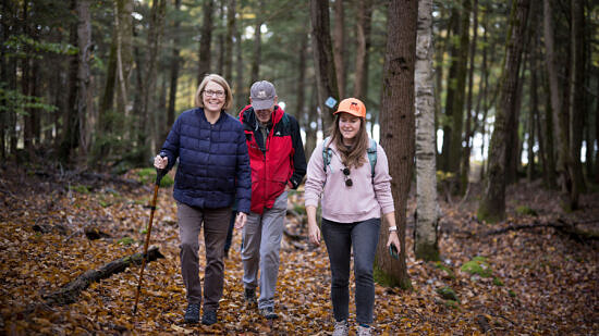 Three hikers in the woods. (photo © Ben Conant)