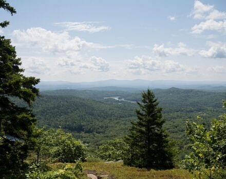 A scenic view of a lake, mountains, and trees (Photo by Ben Conant)