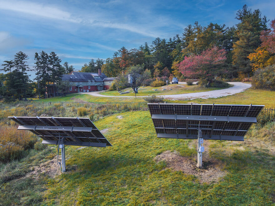 Two solar panels in a field by the Harris Center building (Photo © James Newsom)