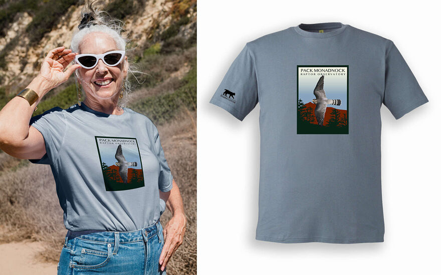 A woman modeling a gray t-shirt with the Pack Monadnock Raptor Observatory logo (art by Caroline Fegley)