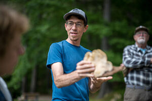 John Benjamin holding a mushroom (photo © Ben Conant)