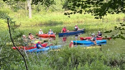Kayaks in a circle on the Conotoocook River (photo by Stan Smith)