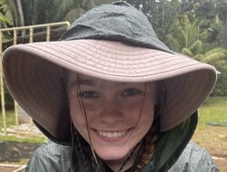 Maya Carey smiles while holding a small turtle
