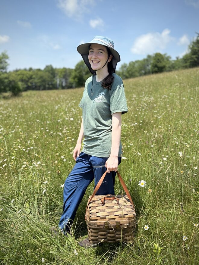Kate McKay in a field in Harrisville during kestrel monitoring (photo © Michelle Aldredge)