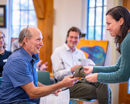 Former Board Chair Michael George passes the hat onto new Board Chair Tara Kessler (photo © Ben Conant)