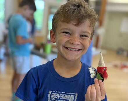 A boy holding a gnome (photo © Michelle Aldredge)