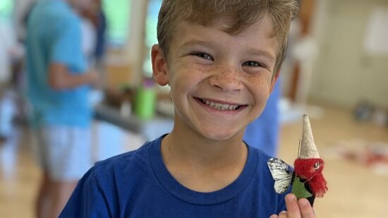 A boy holding a gnome (photo © Michelle Aldredge)