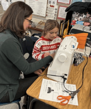 When winter winds made outdoor lessons daunting, Tina rallied the community to bring sewing machines into school so students could make their own neck gaiters. (photo © Tina Ramsey)