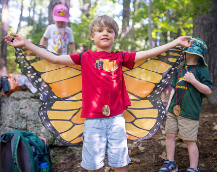 A boy with butterfly wings during summer camp (photo © Ben Conant)
