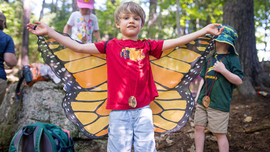 A boy with butterfly wings during summer camp (photo © Ben Conant)