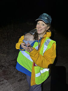 Salamander Brigade volunteer Sarah Thomas with her baby Asa and a spotted salamander on a migration night at Summer Street in Peterborough. (photo © Sarah Thomas)