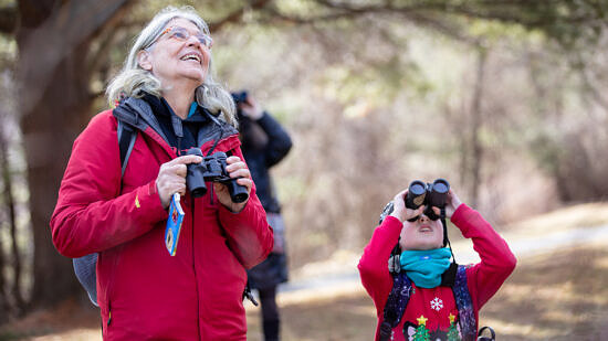 A grandmother and grandchild birding together on a Harris Center field trip. (photo @ Martha Duffy)
