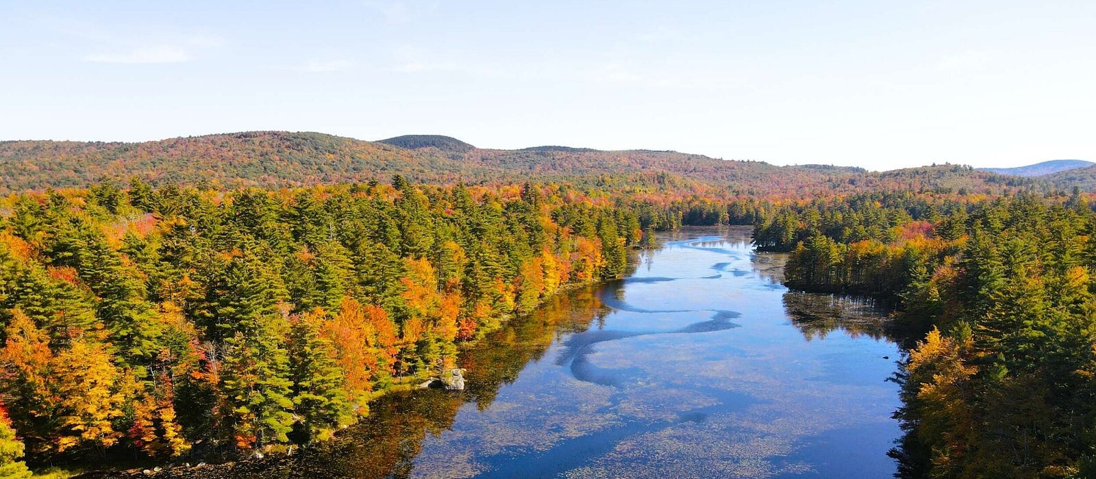 An aerial view of Robb Reservoir and surrounding conservation lands in full autumn foliage (photo © James Newsom)