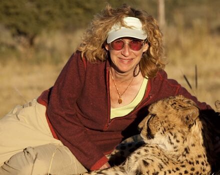 Sy Montgomery with a cheetah in Namibia (photo © Nic Bishop)