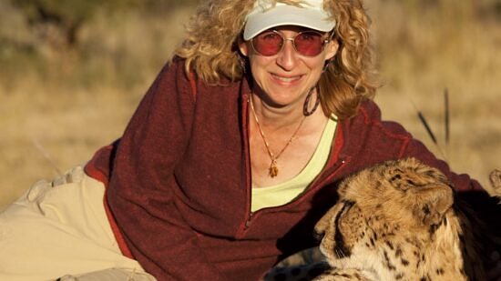 Sy Montgomery with a cheetah in Namibia (photo © Nic Bishop)