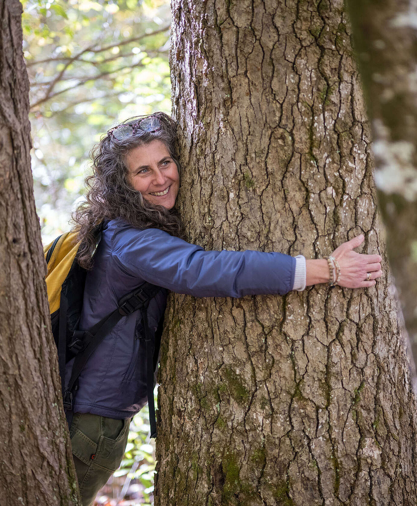 Susie Spikol hugging a tree (photo © Ben Conant)