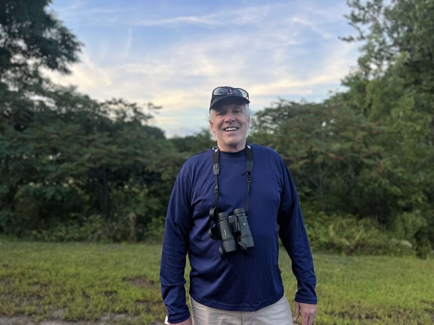 Michael Rafferty with binoculars at a Harris Center birding outing. (photo © Brett Amy Thelen)