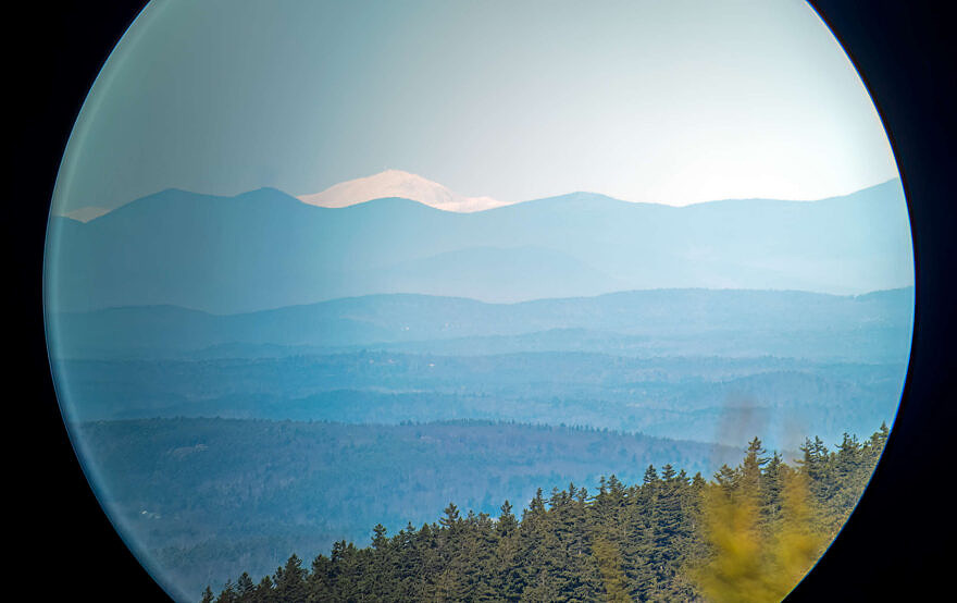 Mount Washington scope view from Pack Monadnock Raptor Observatory, Peterborough, NH, 11/10/24, approximately 100 miles distance. Mobile phone attached to spotting scope (digiscoped photo). Left shoulder of North Pack Monadnock in the foreground. (photo © Tom Momeyer)