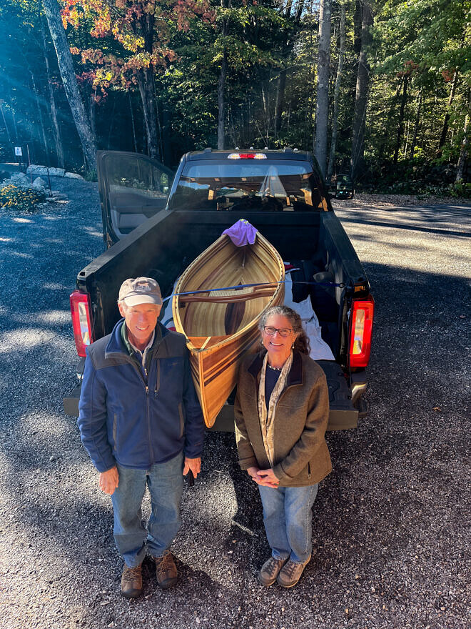 Julia Pakradooni of Harrisville (right) won the handcrafted wooden canoe donated by Hunt Dowse (left). (Photo © Ben Conant)